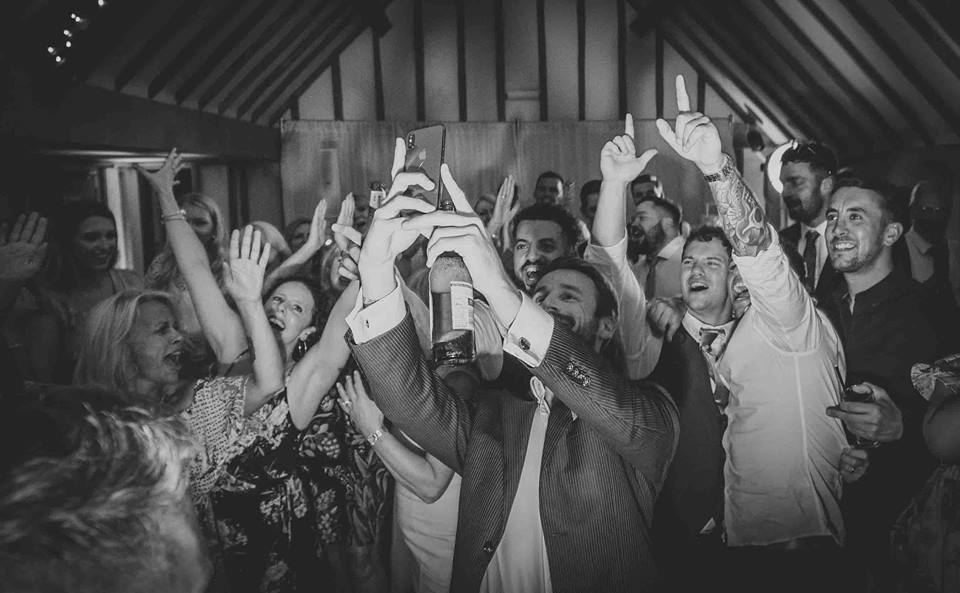 Crowd dancing to the wedding dj