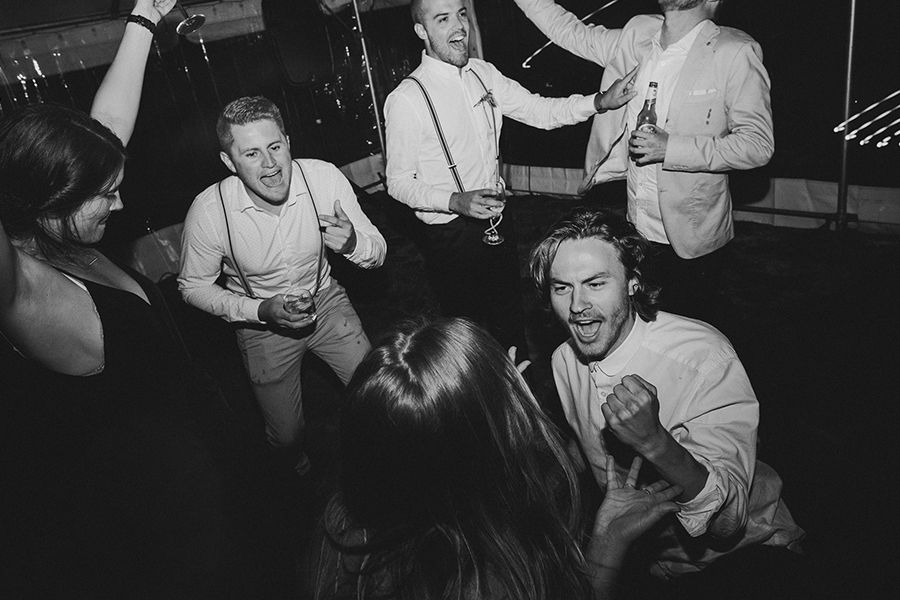 Crowd dancing to music at the wedding